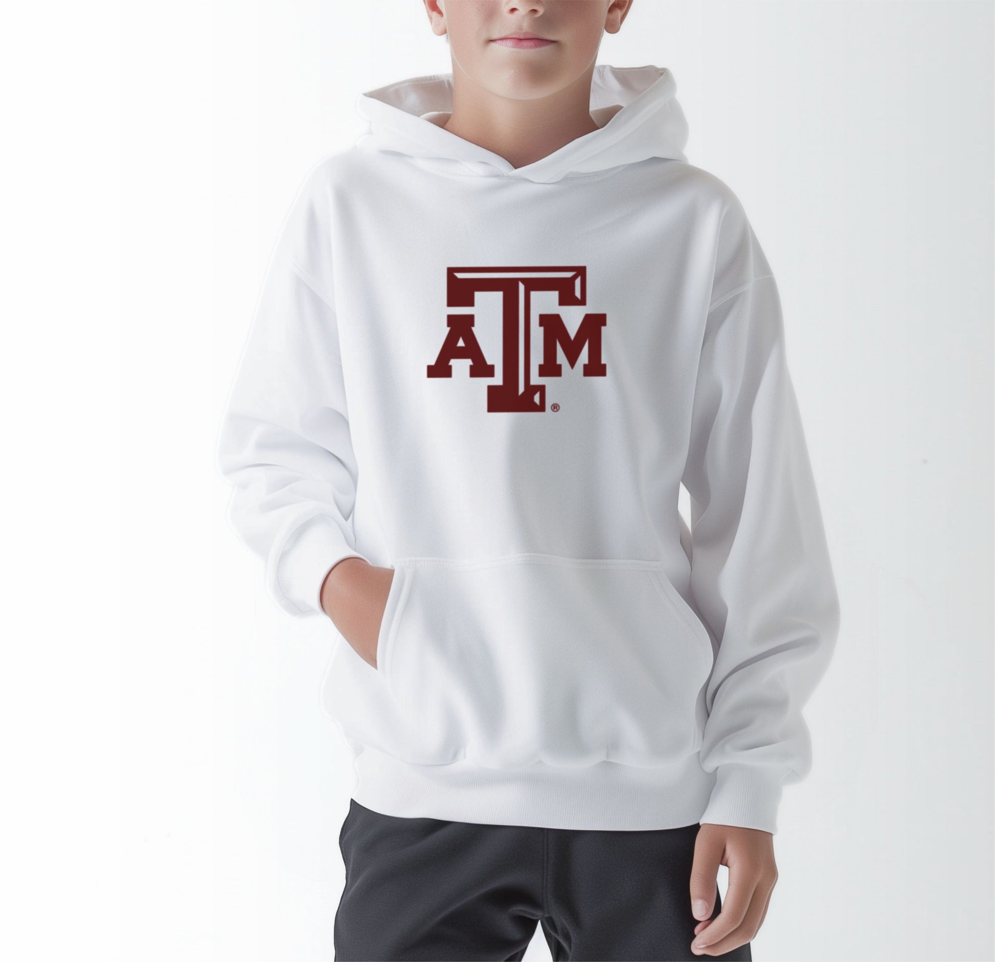 A model wears the White Youth Unisex Texas A&M Logo Hooded Sweatshirt.  The ﻿Texas A&M Logo﻿ graphic is in bold Maroon in a Varsity style.