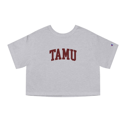 The Oxford Grey Adult Womens Texas A&M TAMU Crop Top lays flat on a white background. The ﻿Texas A&M TAMU﻿ graphic is in bold Maroon in a Collegiate style.