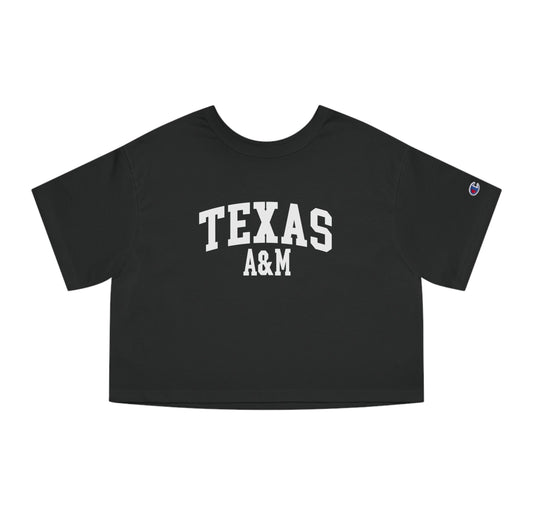 The Black Adult Womens Texas A&M Varsity Crop Top lays flat on a white background. The ﻿Texas A&M Varsity﻿ graphic is in bold White in a Collegiate style.