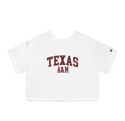 The White Adult Womens Texas A&M Varsity Crop Top lays flat on a white background. The ﻿Texas A&M Varsity﻿ graphic is in bold Maroon in a Collegiate style.