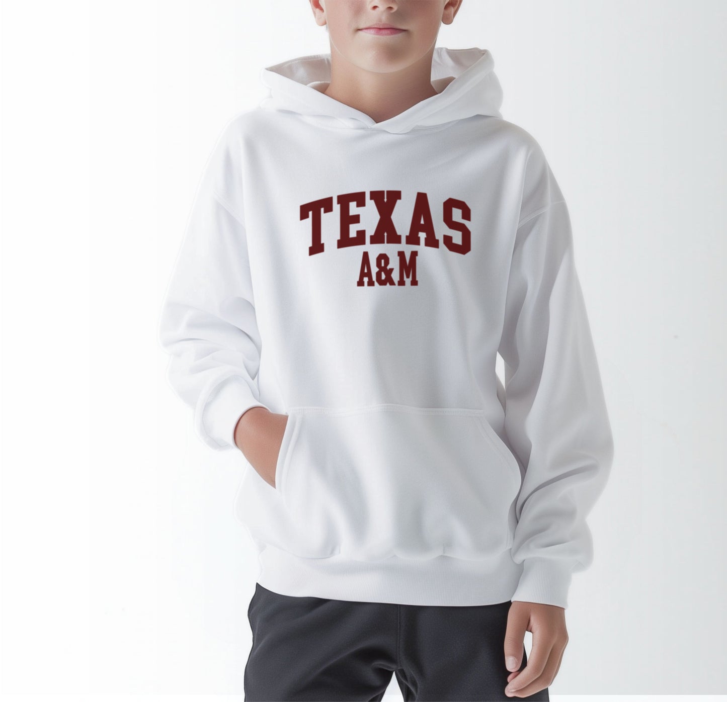 A model wears the White Youth Unisex Texas A&M Varsity Hooded Sweatshirt.  The ﻿Texas A&M Varsity﻿ graphic is in bold Maroon in a Collegiate style.