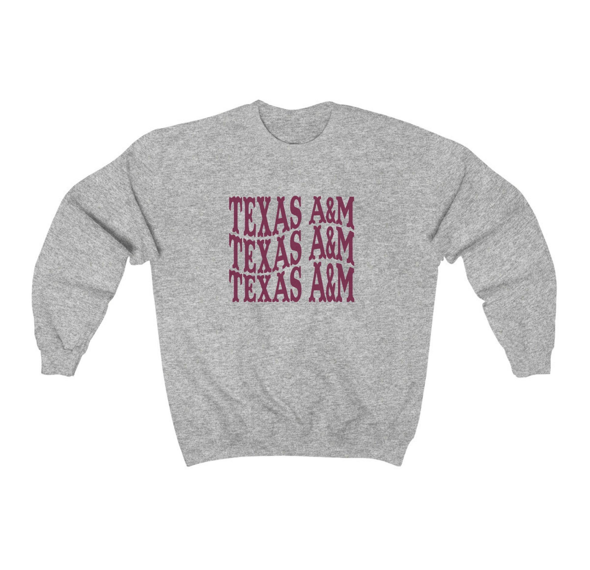 The Sport Grey Adult Unisex Texas A&M Western Crewneck Sweatshirt lays flat on a white background. The ﻿Texas A&M Western﻿ graphic is in bold Maroon in a Western style.