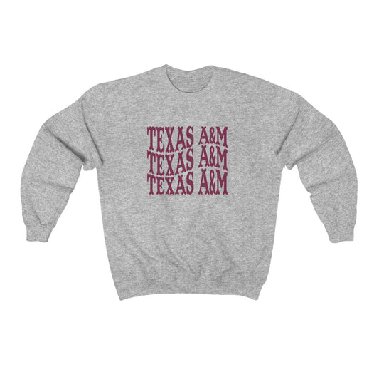 The Sport Grey Adult Unisex Texas A&M Western Crewneck Sweatshirt lays flat on a white background. The ﻿Texas A&M Western﻿ graphic is in bold Maroon in a Western style.