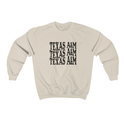 The Sand Adult Unisex Texas A&M Western Crewneck Sweatshirt lays flat on a white background. The ﻿Texas A&M Western﻿ graphic is in bold Black in a Western style.