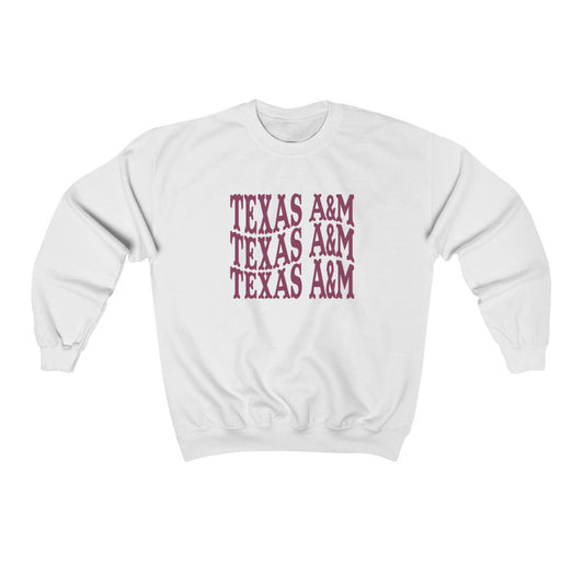 The White Adult Unisex Texas A&M Western Crewneck Sweatshirt lays flat on a white background. The ﻿Texas A&M Western﻿ graphic is in bold Maroon in a Western style.