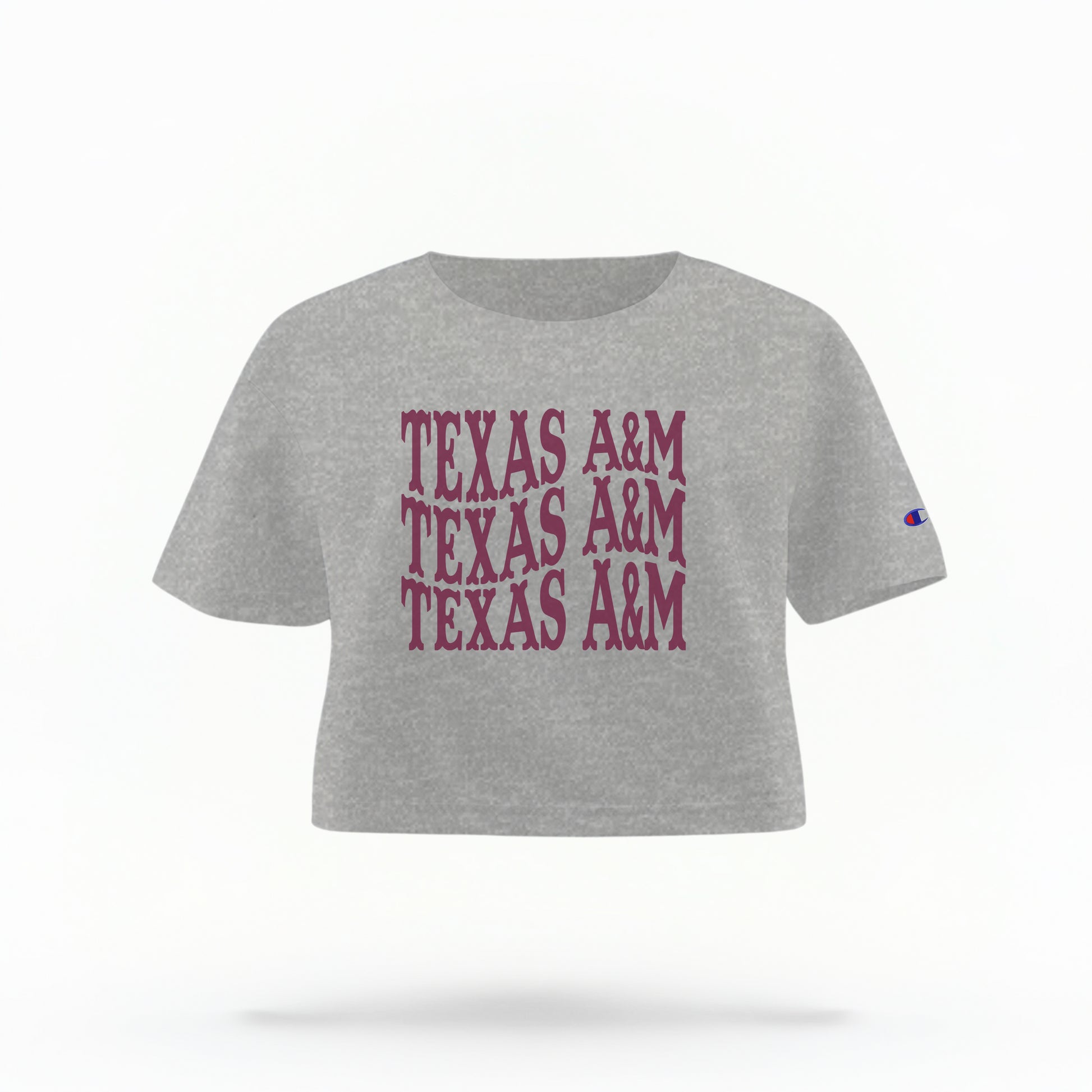 The Oxford Grey Adult Womens Texas A&M Western Crop Top lays flat on a white background. The ﻿Texas A&M Western﻿ graphic is in bold Maroon in a Western style.