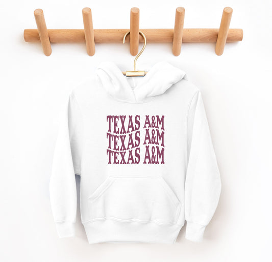 The White Youth Unisex Texas A&M Western Hooded Sweatshirt lays flat on a white background. The ﻿Texas A&M Western﻿ graphic is in bold Maroon in a Western style.