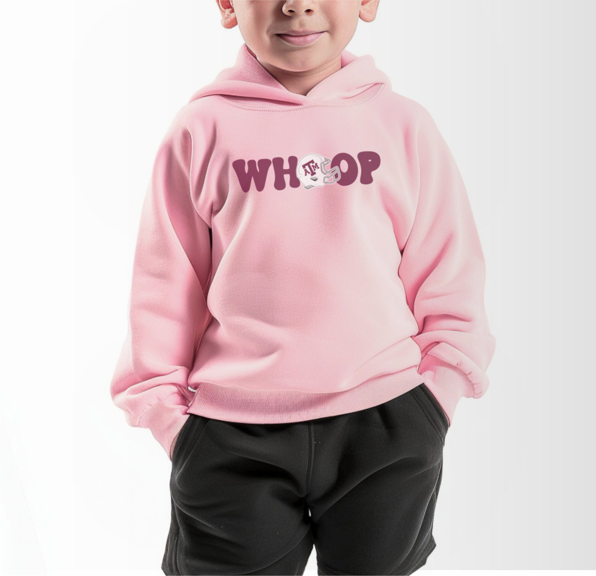 A model wears the Pink Toddler Unisex Texas A&M Retro Whoop Hooded Sweatshirt.  The ﻿Texas A&M Retro Whoop﻿ graphic is in bold White in a Vintage style.