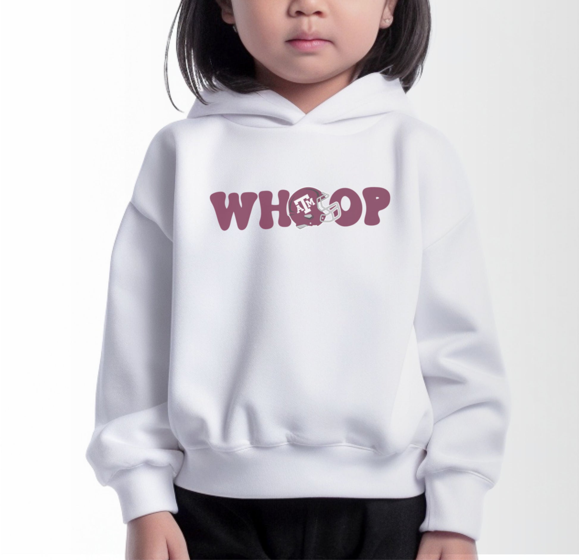 A model wears the White Toddler Unisex Texas A&M Retro Whoop Hooded Sweatshirt.  The ﻿Texas A&M Retro Whoop﻿ graphic is in bold Maroon in a Vintage style.