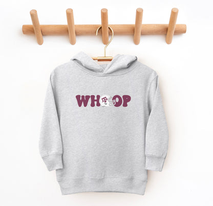 The Heather Grey Toddler Unisex Texas A&M Retro Whoop Hooded Sweatshirt lays flat on a white background. The ﻿Texas A&M Retro Whoop﻿ graphic is in bold Maroon in a Vintage style.