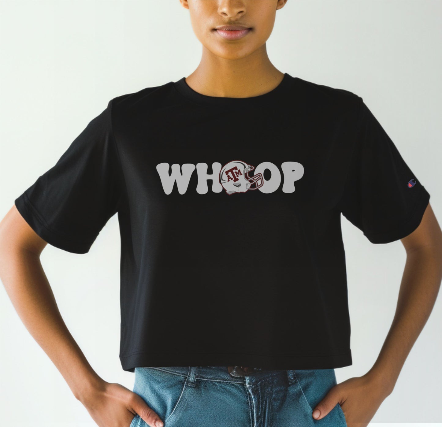 A model wears the Black Adult Womens Texas A&M Retro Whoop Crop Top.  The ﻿Texas A&M Retro Whoop﻿ graphic is in bold White in a Vintage style.