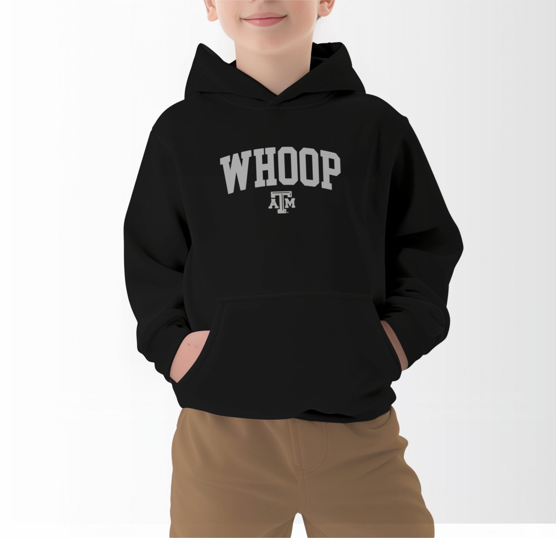 A model wears the Black Youth Unisex Texas A&M Whoop Collegiate Hooded Sweatshirt.  The ﻿Texas A&M Whoop Collegiate﻿ graphic is in bold White in a Varsity style.