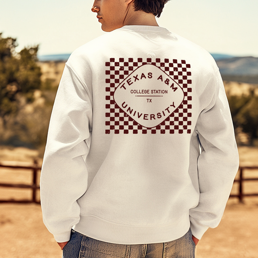 A model wears the white Texas A&M Crewneck Sweatshirt. The graphic contains a retro checkered pattern. 