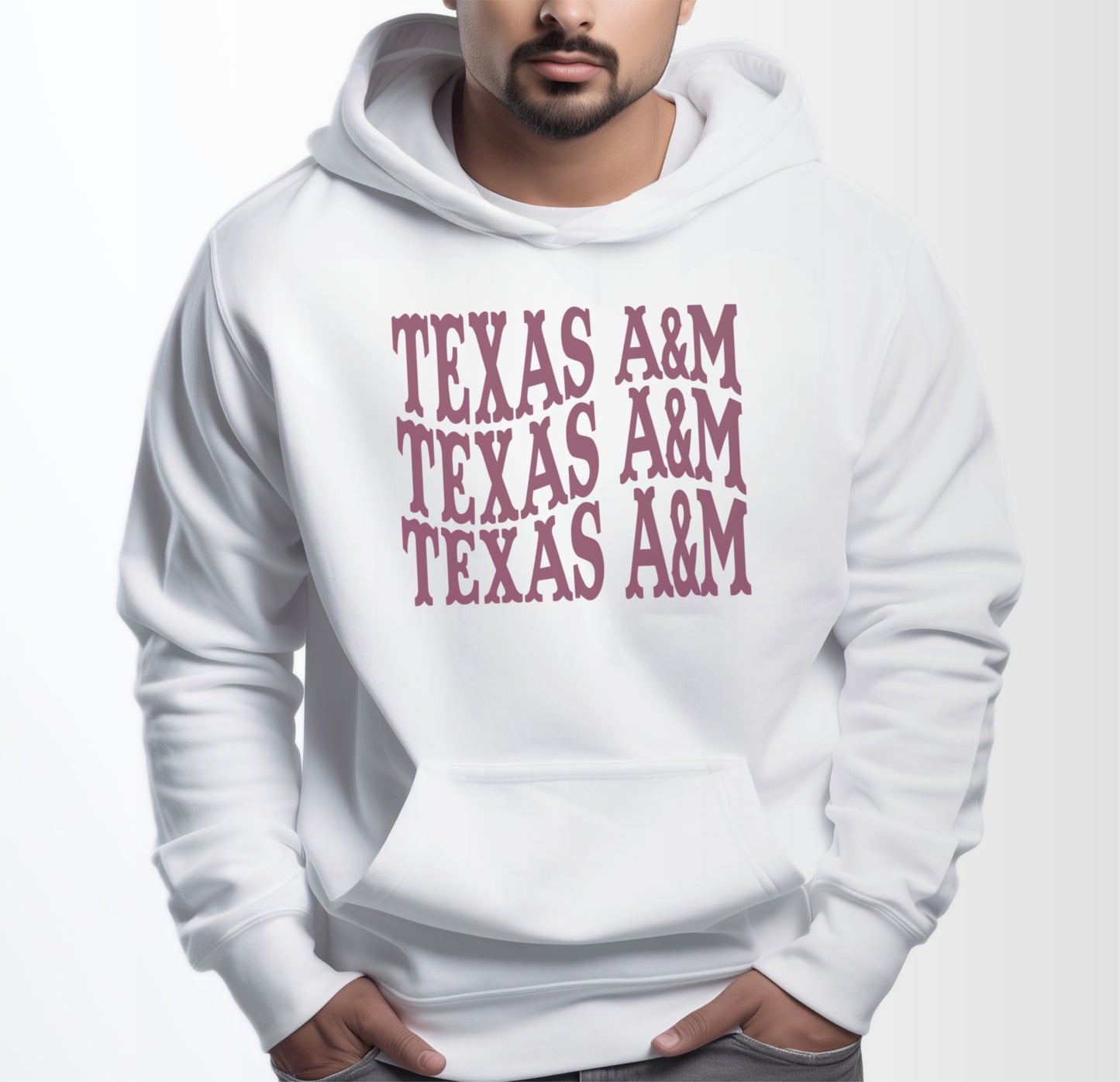 A model wears the White Adult Unisex Texas A&M Western Hooded Sweatshirt.  The ﻿Texas A&M Western﻿ graphic is in bold Maroon in a Western style.