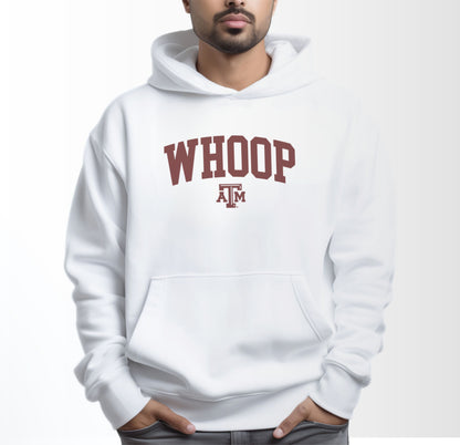 A model wears the White Adult Unisex Texas A&M Whoop Collegiate Hooded Sweatshirt.  The ﻿Texas A&M Whoop Collegiate﻿ graphic is in bold Maroon in a Varsity style.