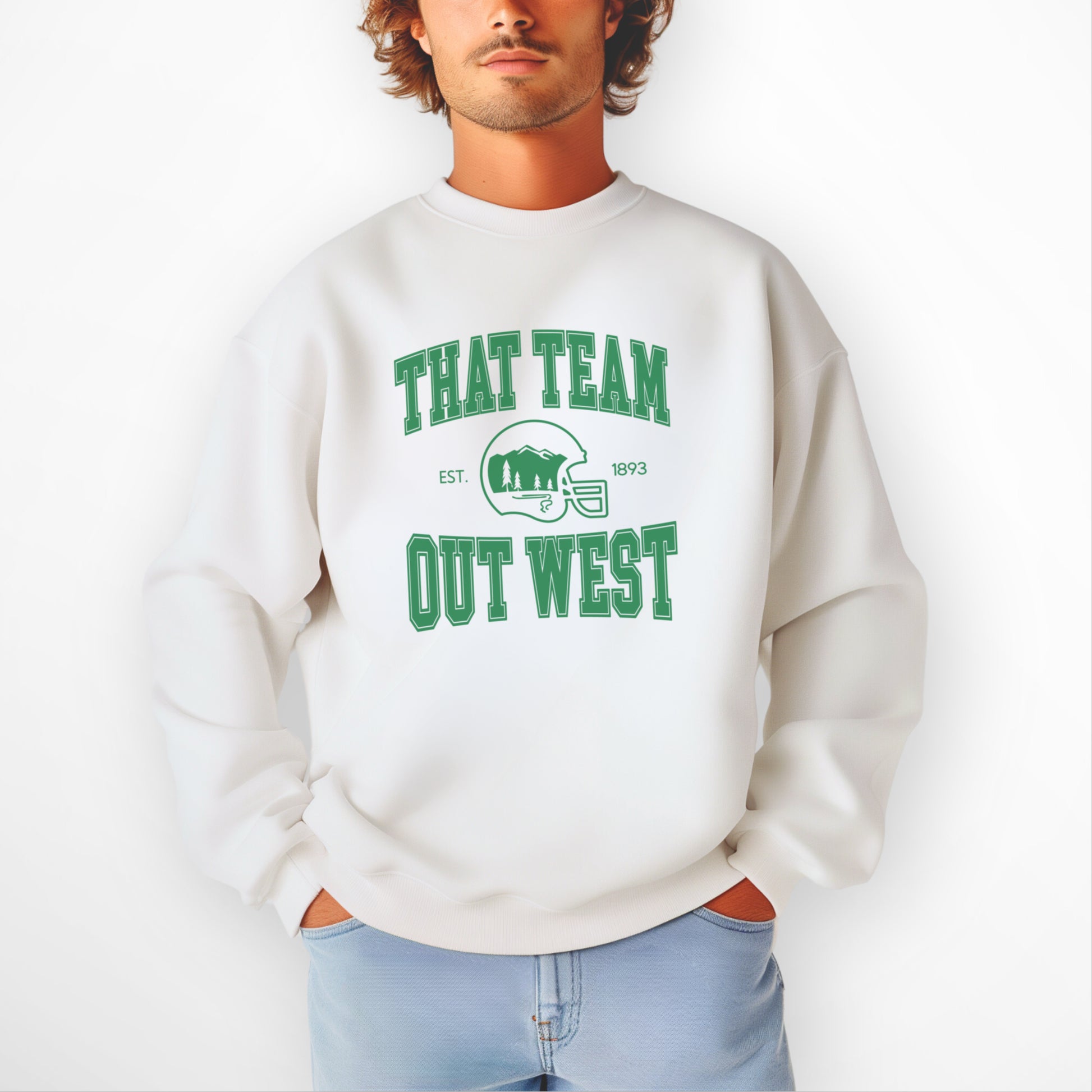 A mens model wears the That team out west Crewneck Sweatshirt. The graphic is in bold Green in a collegiate style.