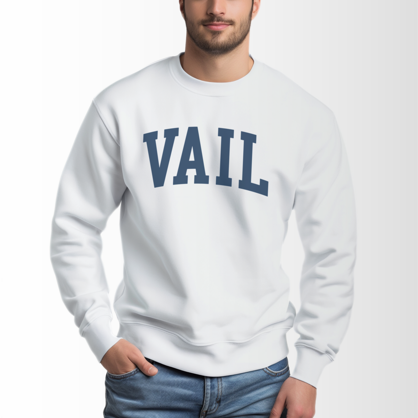 A model wears the White Vail Colorado Varsity Crewneck Sweatshirt.  The ﻿Vail Colorado Varsity﻿ graphic is in bold Navy in a Collegiate style.