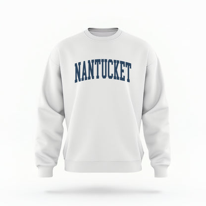 The white Unisex Nantucket Varsity Crewneck Sweatshirt lays flat on a white background. The Nantucket graphic is in bold navy and varsity offset style.
