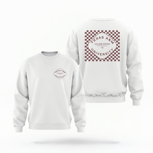 A white Texas A&M Crewneck Sweatshirt lays flat on white background. The graphic contains a retro checkered pattern. 