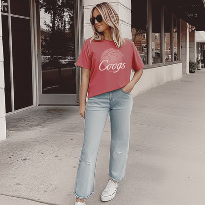 A model wears the red Houston Cougars Basketball vintage t-shirt.  The ﻿Houston Cougars Basketball graphic is in bold white in a scripted font style.