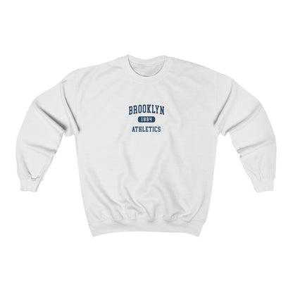 The White Brooklyn Athletics Crewneck Sweatshirt lays flat on a white background. The ﻿Brooklyn Athletics﻿ graphic is in bold Navy in a Varsity style.