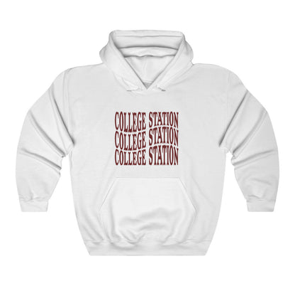 The White Adult Unisex College Station Western Hooded Sweatshirt lays flat on a white background. The ﻿College Station Western﻿ graphic is in bold Maroon in a Western style.