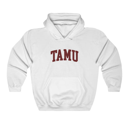 The White Adult Unisex Texas A&M TAMU Hooded Sweatshirt lays flat on a white background. The ﻿Texas A&M TAMU﻿ graphic is in bold Maroon in a Collegiate style.