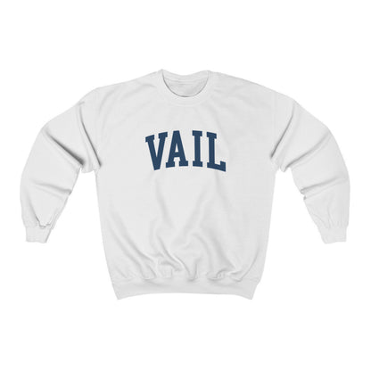 The White Vail Colorado Varsity Crewneck Sweatshirt lays flat on a white background. The ﻿Vail Colorado Varsity﻿ graphic is in bold Navy in a Collegiate style.