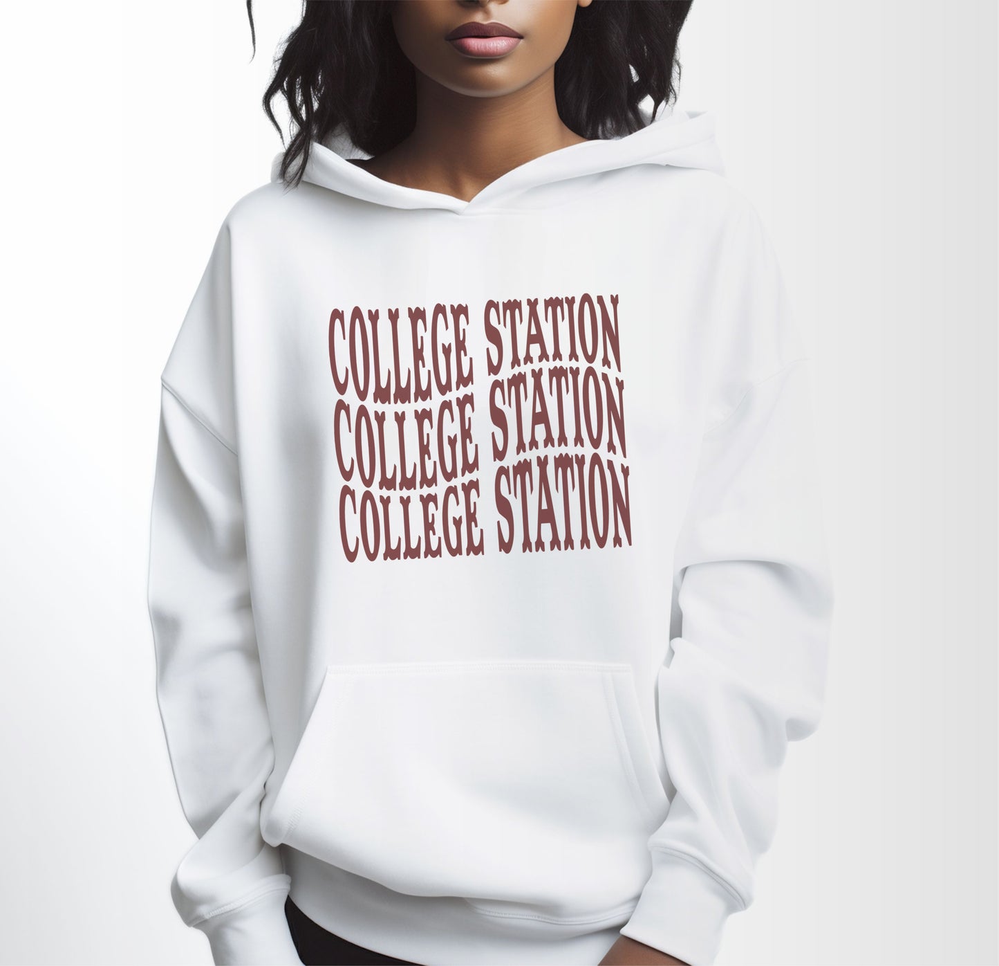 A model wears the White Adult Unisex College Station Western Hooded Sweatshirt.  The ﻿College Station Western﻿ graphic is in bold Maroon in a Western style.