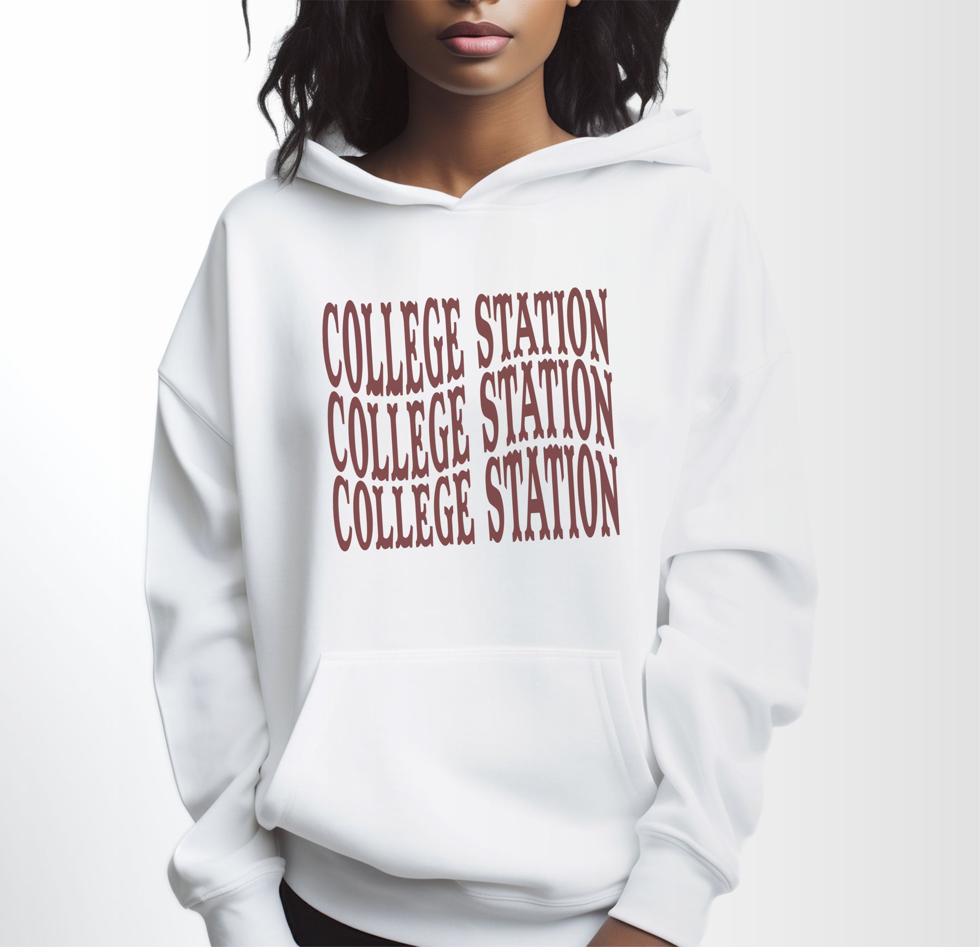 A model wears the White Adult Unisex College Station Western Hooded Sweatshirt.  The ﻿College Station Western﻿ graphic is in bold Maroon in a Western style.