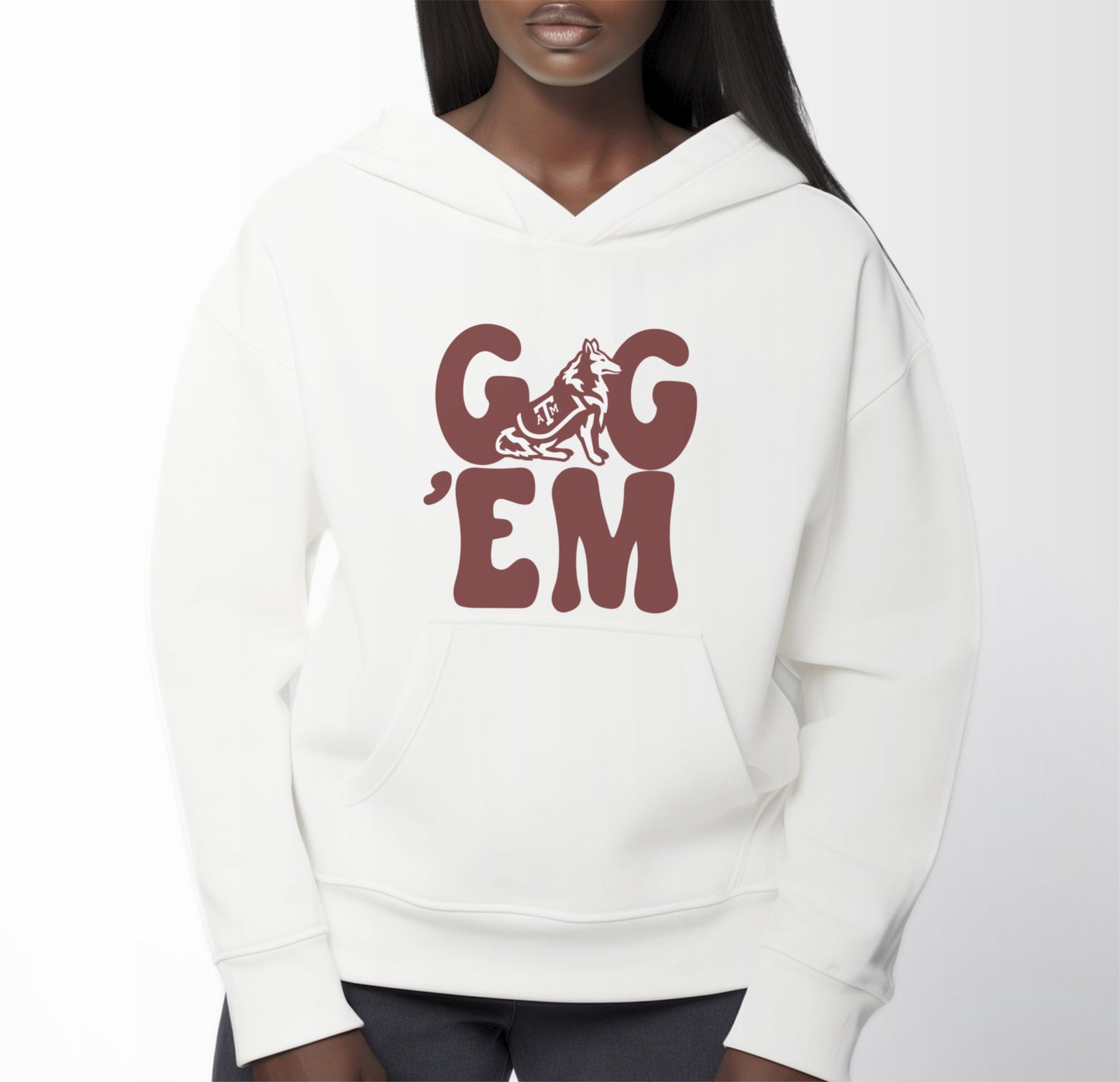 A model wears the White Adult Unisex Texas A&M Gig 'Em Retro Reveille Hooded Sweatshirt.  The ﻿Texas A&M Gig 'Em Retro Reveille﻿ graphic is in bold Maroon in a Groovy Vintage style.