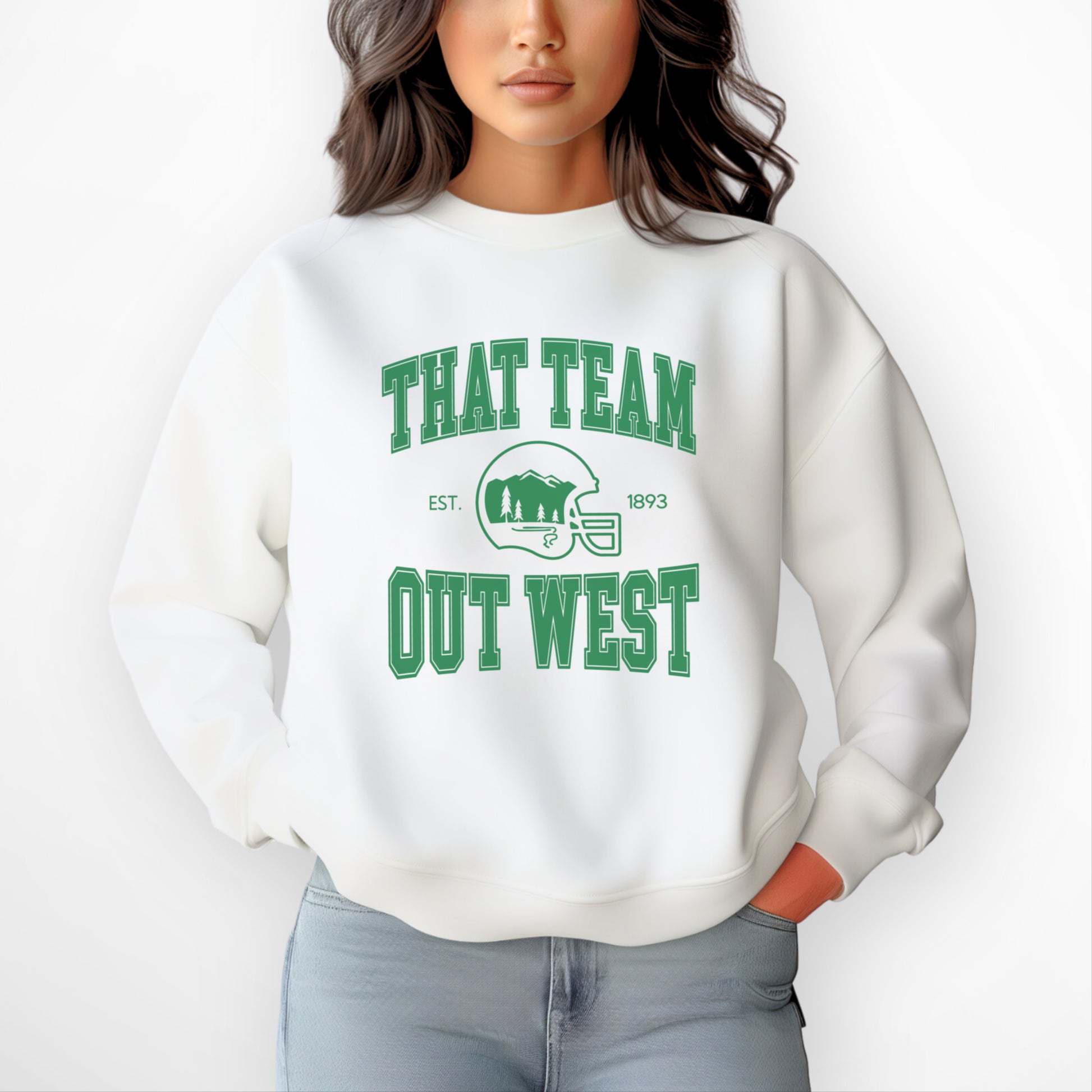 A womens model wears the That team out west Crewneck Sweatshirt. The graphic is in bold Green in a collegiate style.