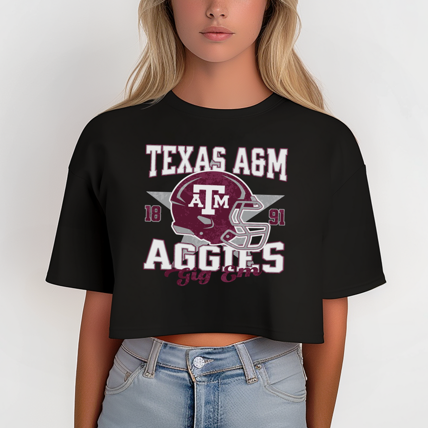 A model wears the Black Texas A&M Aggies Football Crop Top. The ﻿Texas A&M Aggies Football﻿ graphic is in bold Multicolor in a Varsity style.