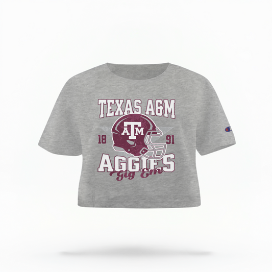 The Oxford Grey Texas A&M Aggies Football Crop Top lays flat on a white background. The ﻿Texas A&M Aggies Football﻿ graphic is in bold Multicolor in a Varsity style.