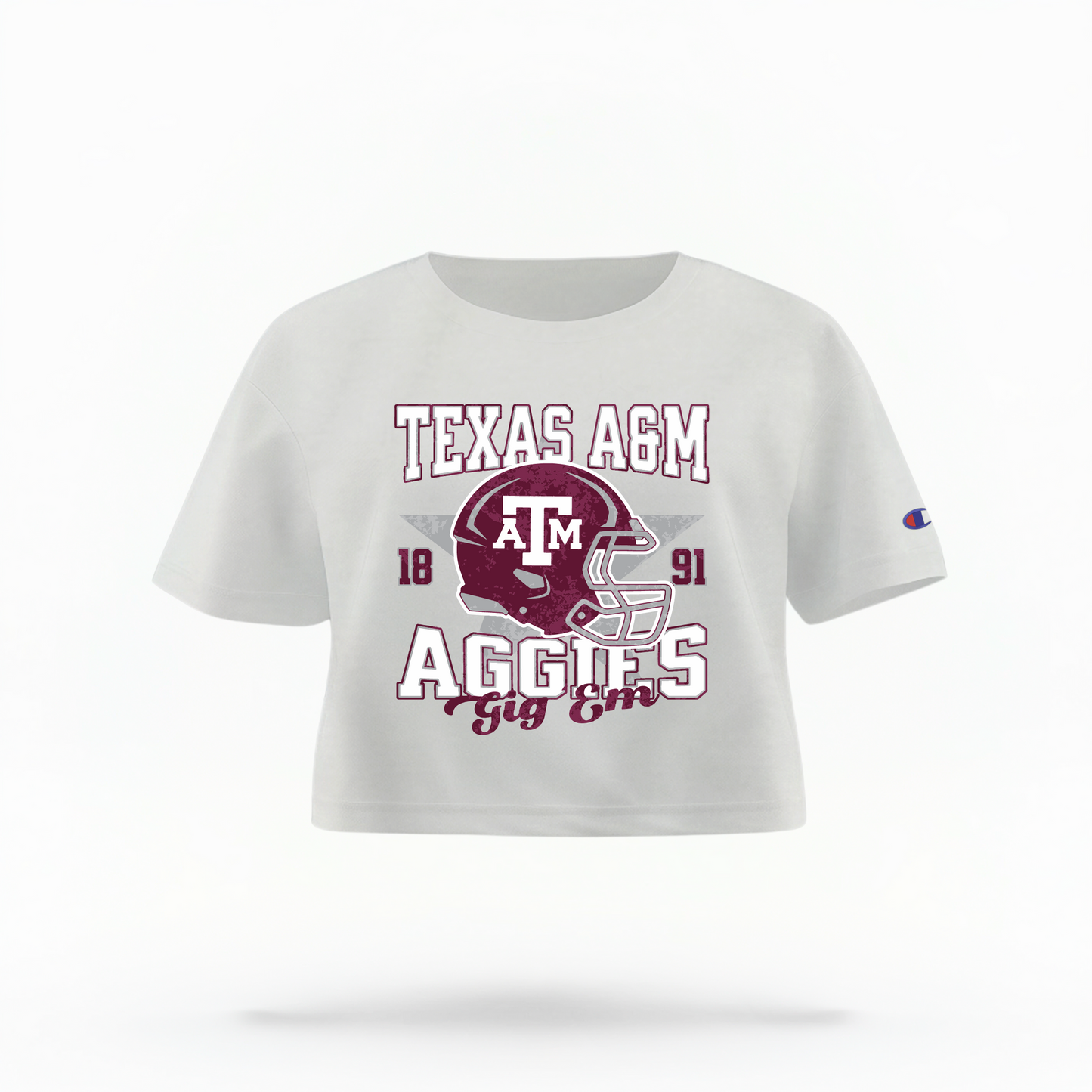 The White Texas A&M Aggies Football Crop Top lays flat on a white background. The ﻿Texas A&M Aggies Football﻿ graphic is in bold Multicolor in a Varsity style.