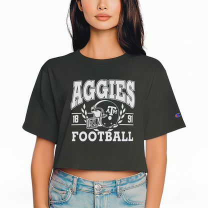 A model wears the Black Texas A&M Aggie Football Crop Top.  The ﻿Texas A&M Aggie Football﻿ graphic is in bold White in a bold style.