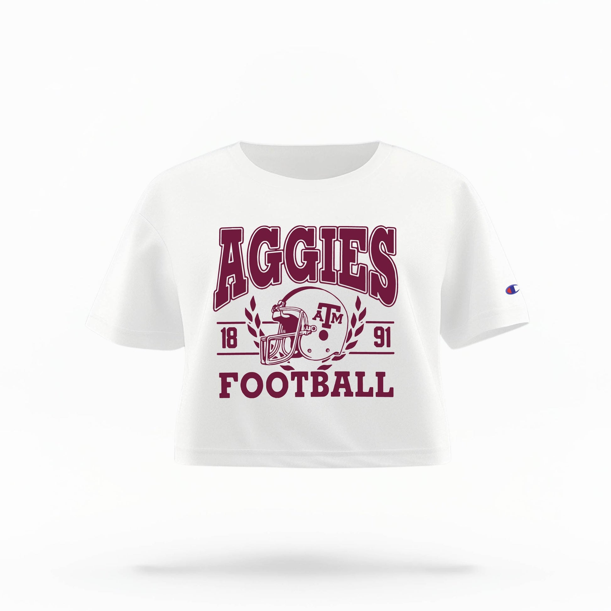 Texas A&M Aggies Women's Crop Top in maroon and white, featuring the "Aggies" logo and a football helmet graphic.