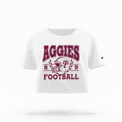 Texas A&M Aggies Women's Crop Top in maroon and white, featuring the "Aggies" logo and a football helmet graphic.