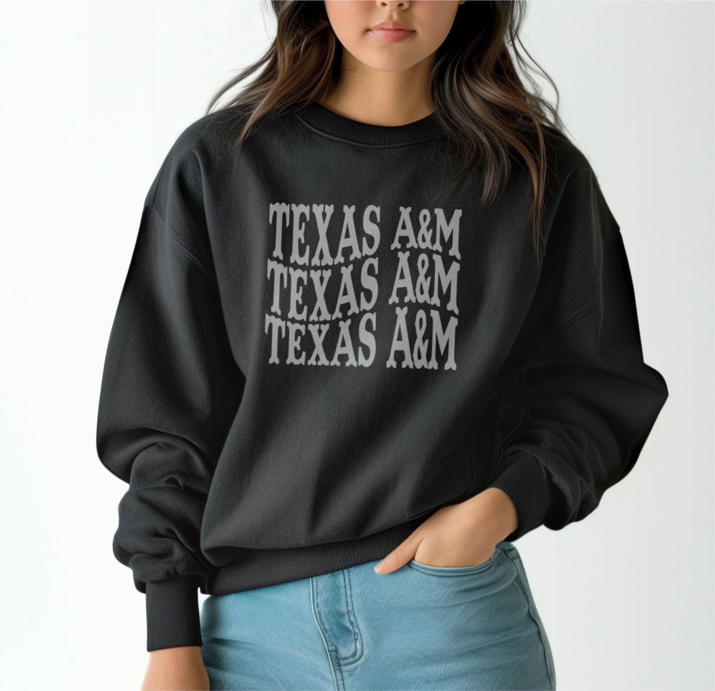 A model wears the Black Adult Unisex Texas A&M Western Crewneck Sweatshirt.  The ﻿Texas A&M Western﻿ graphic is in bold White in a Western style.