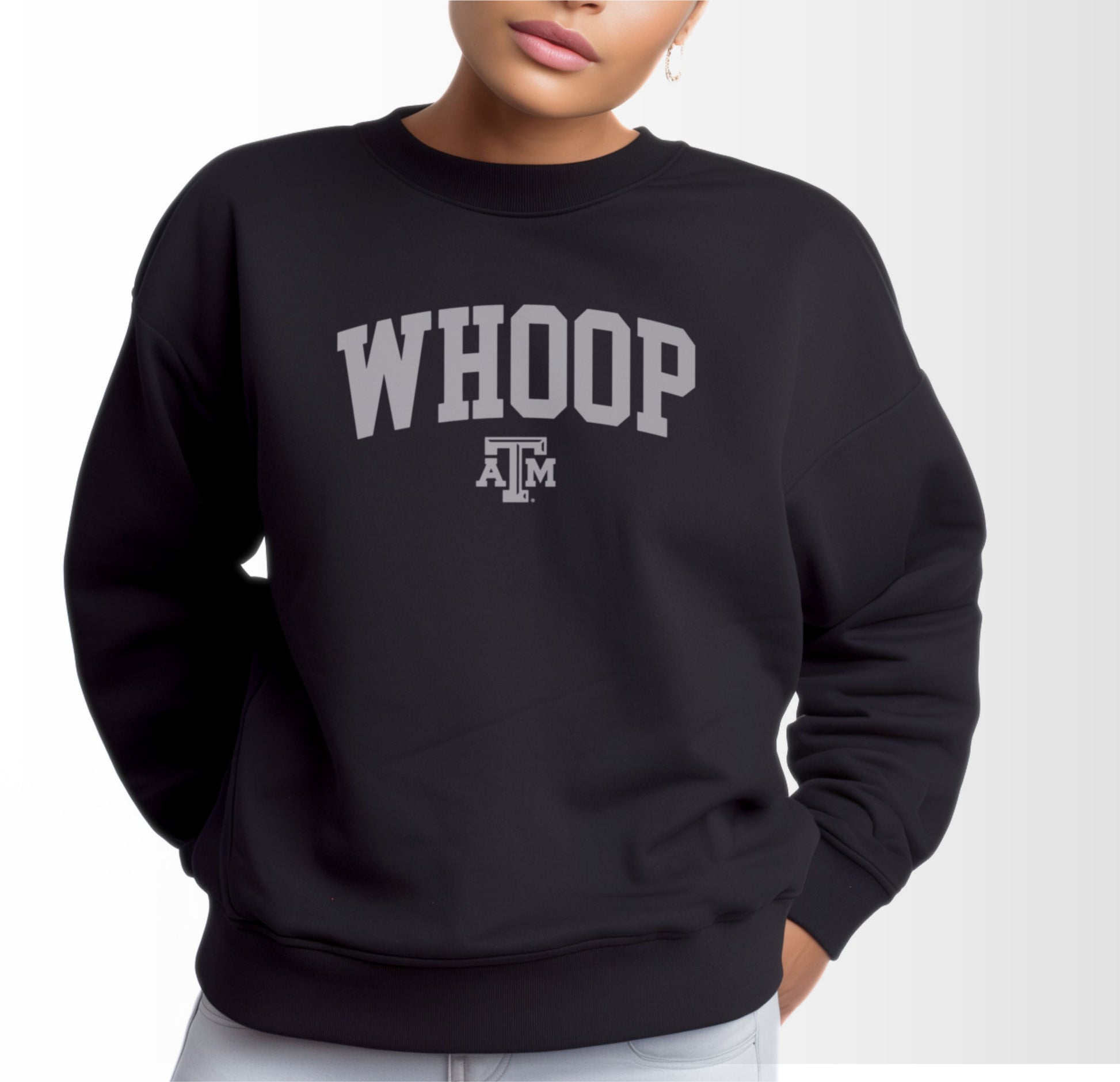 A model wears the Black Adult Unisex Texas A&M Whoop Collegiate Crewneck Sweatshirt.  The ﻿Texas A&M Whoop Collegiate﻿ graphic is in bold White in a Varsity style.