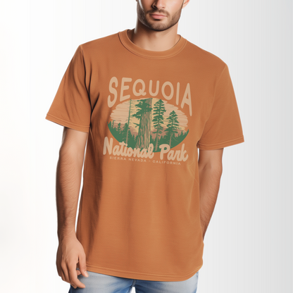 A model wears the Yam Adult Unisex Sequoia National Park Comfort Colors T-shirt.  The ﻿Sequoia National Park﻿ graphic is in bold Lifestyle in a Rustic Park style.