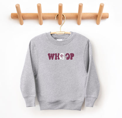 The Sport Grey Youth Unisex Texas A&M Retro Whoop Crewneck Sweatshirt lays flat on a white background. The ﻿Texas A&M Retro Whoop﻿ graphic is in bold Maroon in a Vintage style.