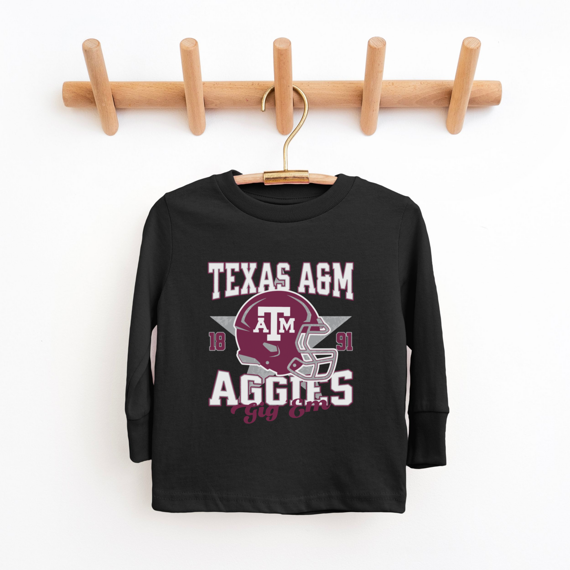 The Black Texas A&M Aggies Football Long Sleeve T-shirt lays flat on a white background. The ﻿Texas A&M Aggies Football﻿ graphic is in bold Multicolor in a Varsity style.