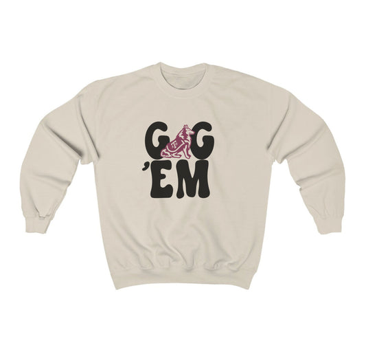 The Sand Adult Unisex Texas A&M Gig 'Em Retro Reveille Crewneck Sweatshirt lays flat on a white background. The ﻿Texas A&M Gig 'Em Retro Reveille﻿ graphic is in bold Black in a Groovy Vintage style.