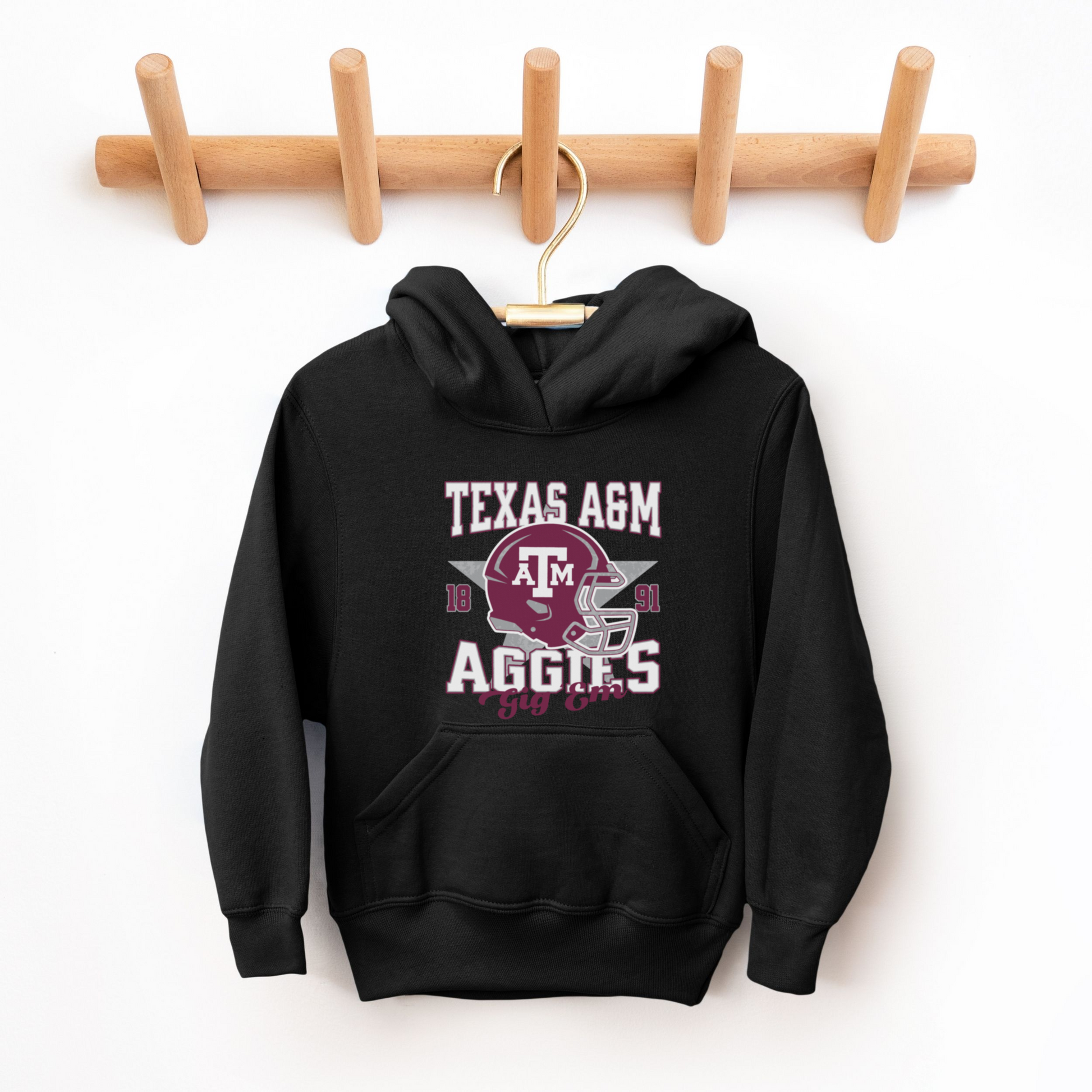 The Black Texas A&M Aggies Football Hooded Sweatshirt lays flat on a white background. The ﻿Texas A&M Aggies Football﻿ graphic is in bold Multicolor in a Varsity style.