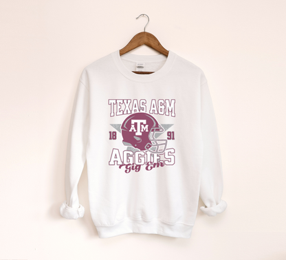 The White Texas A&M Aggies Football Crewneck Sweatshirt lays flat on a white background. The ﻿Texas A&M Aggies Football﻿ graphic is in bold Unisex in a Varsity style.