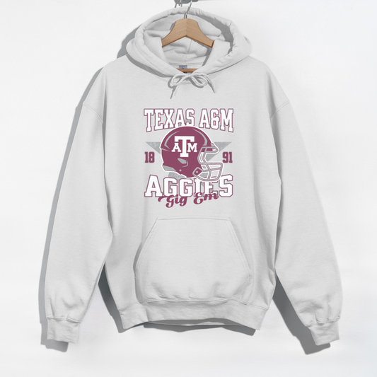 The White Texas A&M Aggies Football Hoodie Sweatshirt lays flat on a white background. The ﻿Texas A&M Aggies Football﻿ graphic is in bold Unisex in a Varsity style.